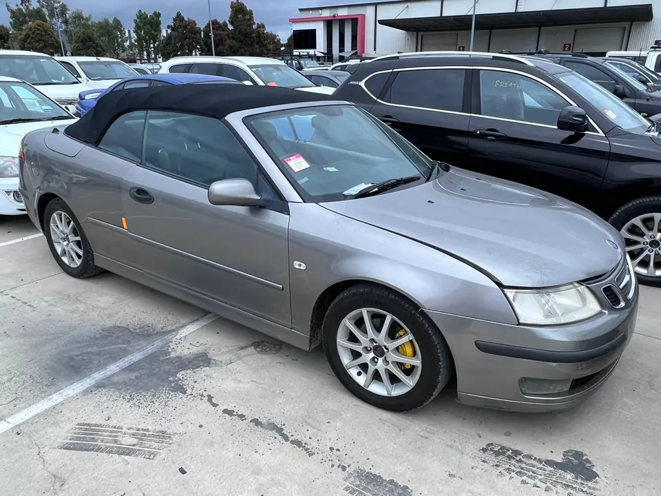 Silver convertible parked in a vehicle yard