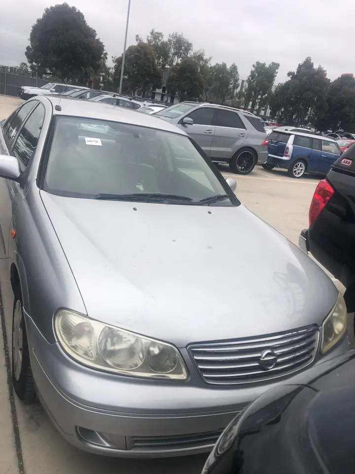 Silver sedan parked beside other cars