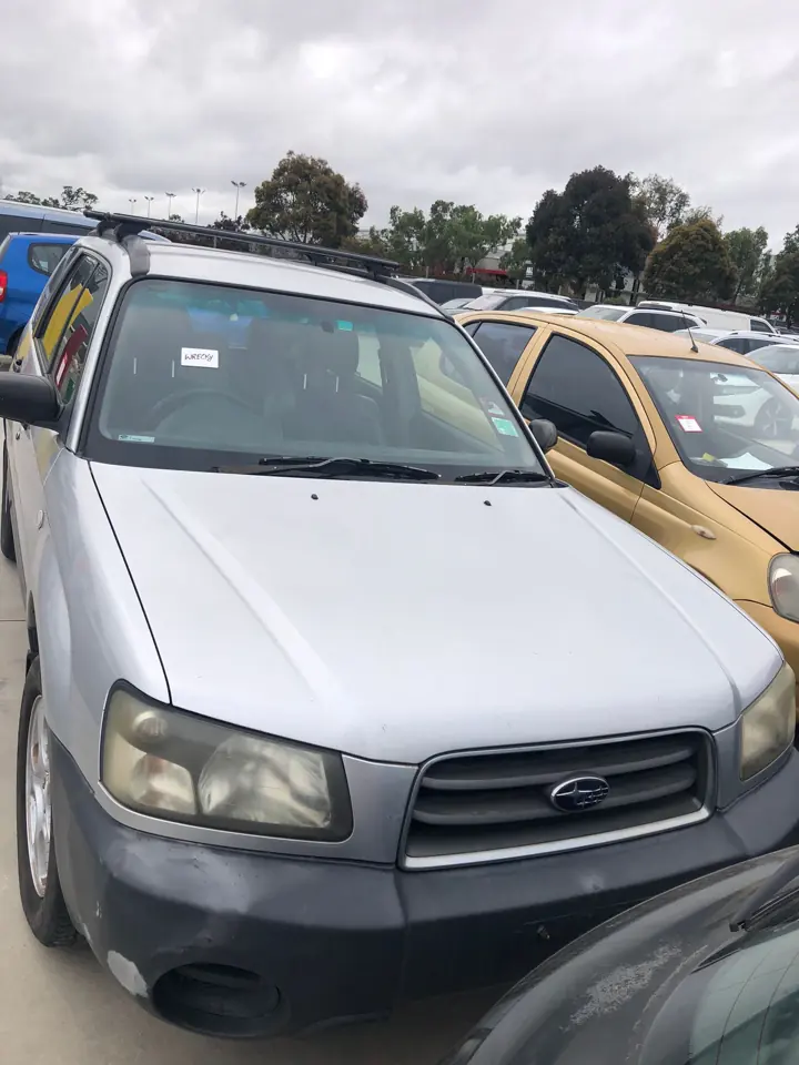 Silver sedan in a vehicle yard