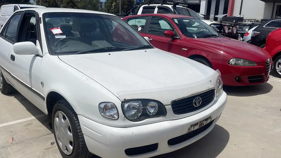 White sedan parked in a vehicle yard