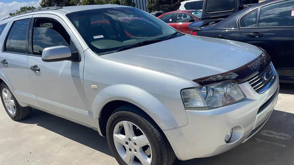 White SUV parked alongside other vehicles