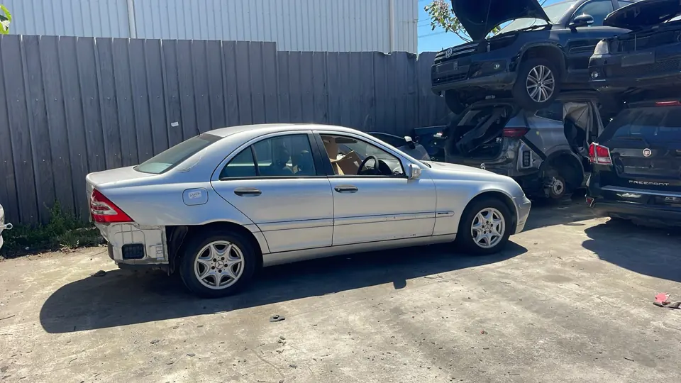 Silver sedan outside a workshop