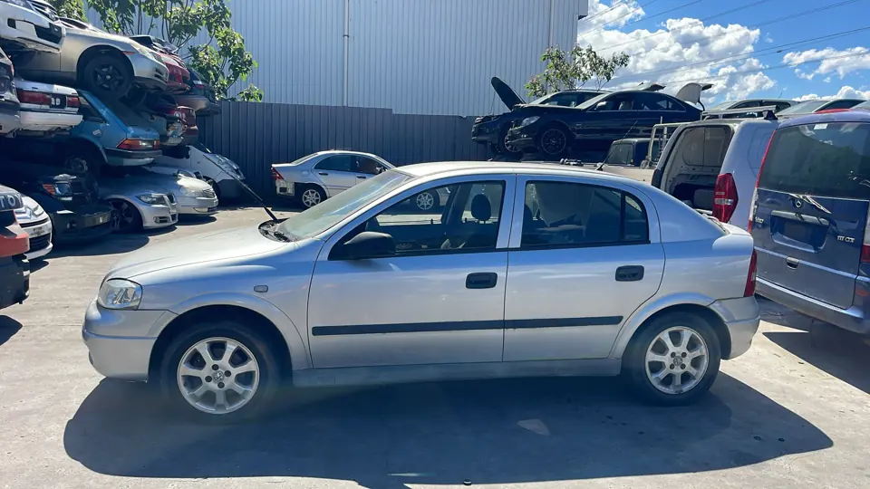 Silver hatchback in a vehicle yard