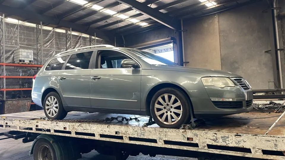 Grey SUV on a flatbed indoors
