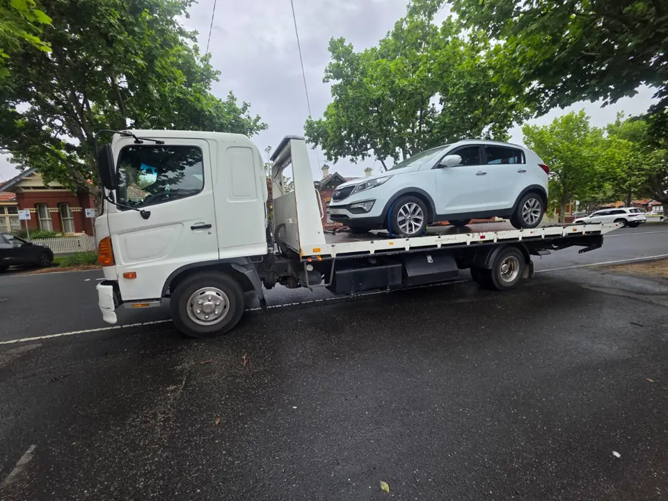White vehicle on a flatbed outdoors