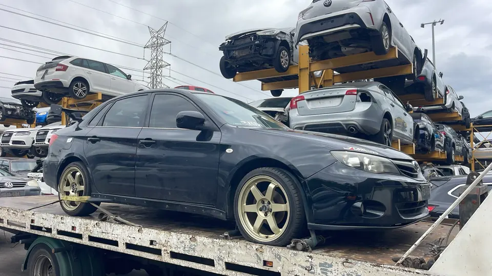 Silver sedan in a vehicle yard