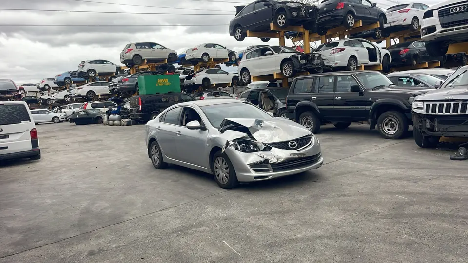 White sedan in a vehicle yard